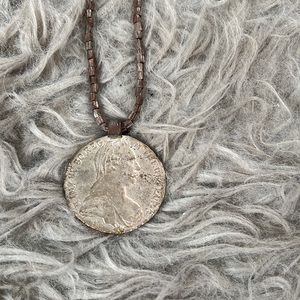 Noonday collection fair trade necklace made of artillery shells, Ethiopian coin.